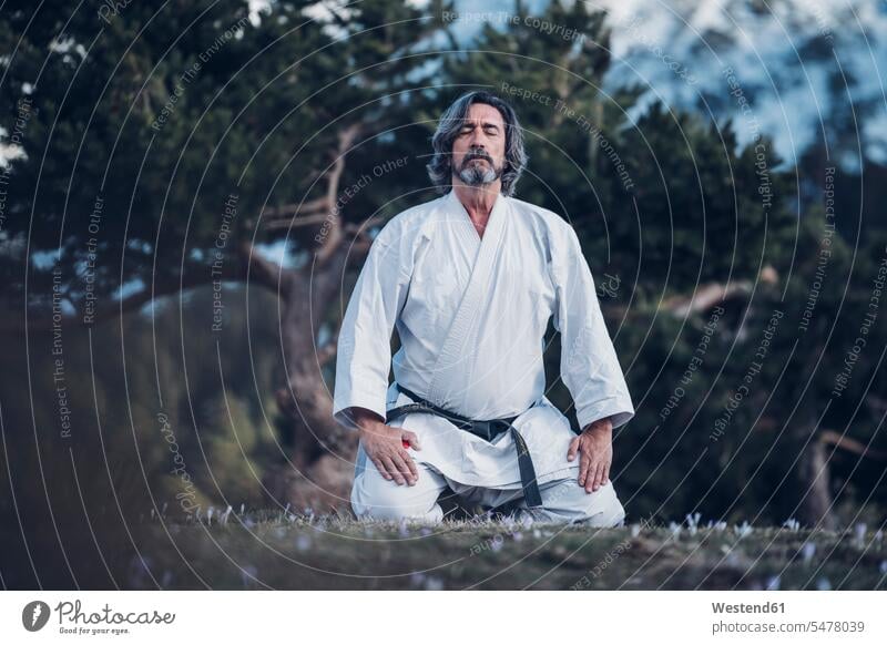 Senior man practicing karate outdoors, meditation men males senior men senior man elder man elder men senior citizen karate fighter karate struggler