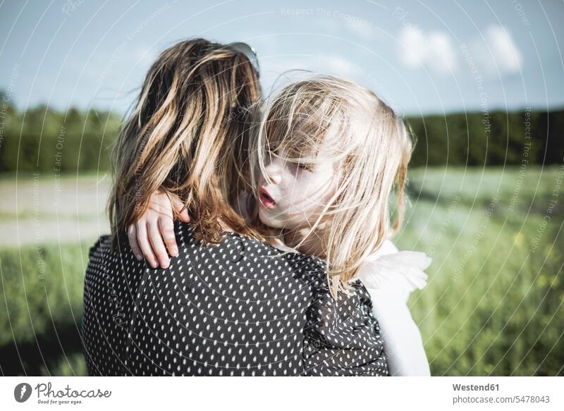 Portrait of little girl on her mother's arms in rape field nature natural world portrait portraits mommy mothers ma mummy mama females girls parents family