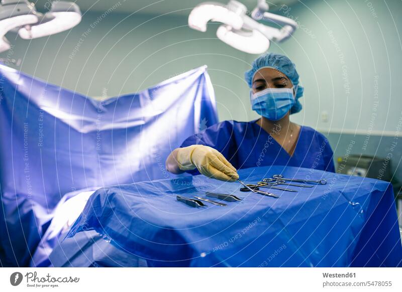 Nurse placing sterilized surgical instruments in operating room human human being human beings humans person persons caucasian appearance caucasian ethnicity