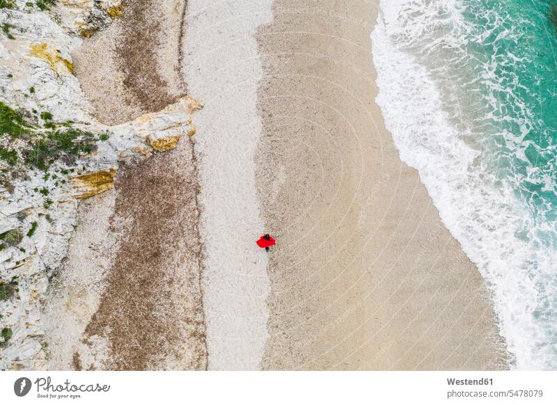 Italy, Elba, woman with red coat walking at beach, aerial view with drone Wanderlust Itchy Feet alone solitary solo Exploration exploring explore females women