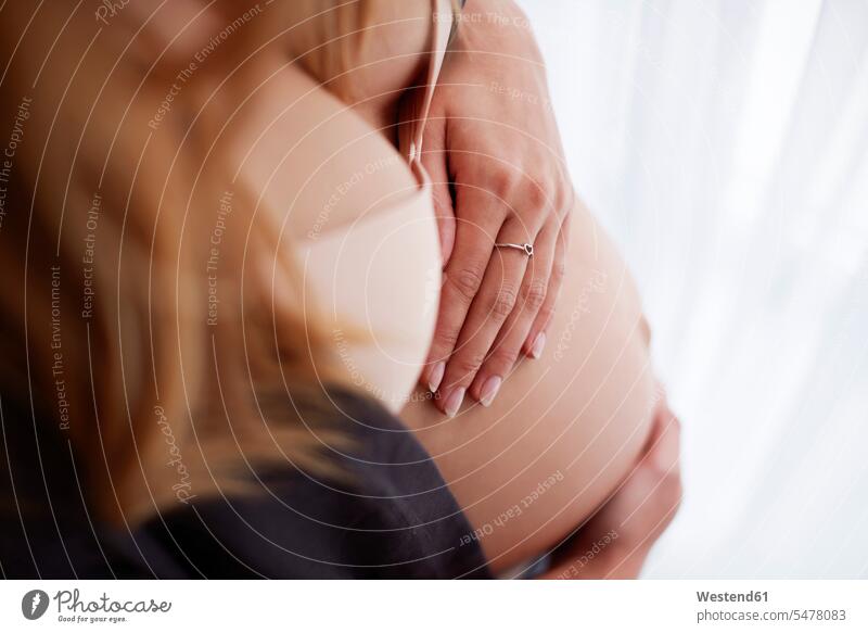 High angle view of pregnant woman baby belly baby bump pregnant belly holding stroking petting Pregnant Woman females women bellies abdomen human abdomen