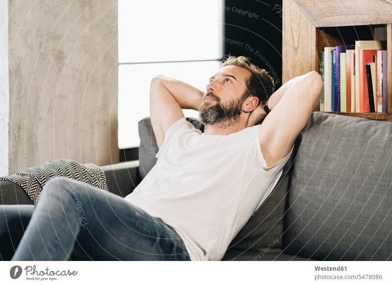 Mature man sitting on couch, contemplating human human being human beings humans person persons caucasian appearance caucasian ethnicity european 1
