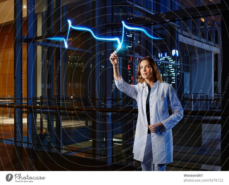 Female doctor light painting heart attack in laboratory at hospital color image colour image indoors indoor shot indoor shots interior interior view Interiors
