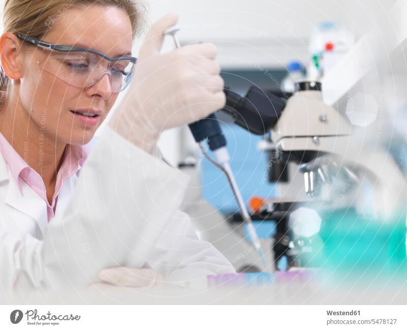 DNA Research, Scientist pipetting a DNA sample into a tube ready for automated analysis in the laboratory Occupation Work job jobs profession