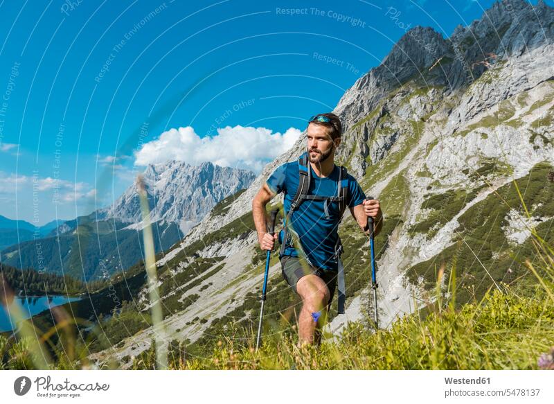 Austria, Tyrol, Young man hiking in the maountains at Lake Seebensee hiker wanderers hikers mountain range mountains mountain ranges young man young men