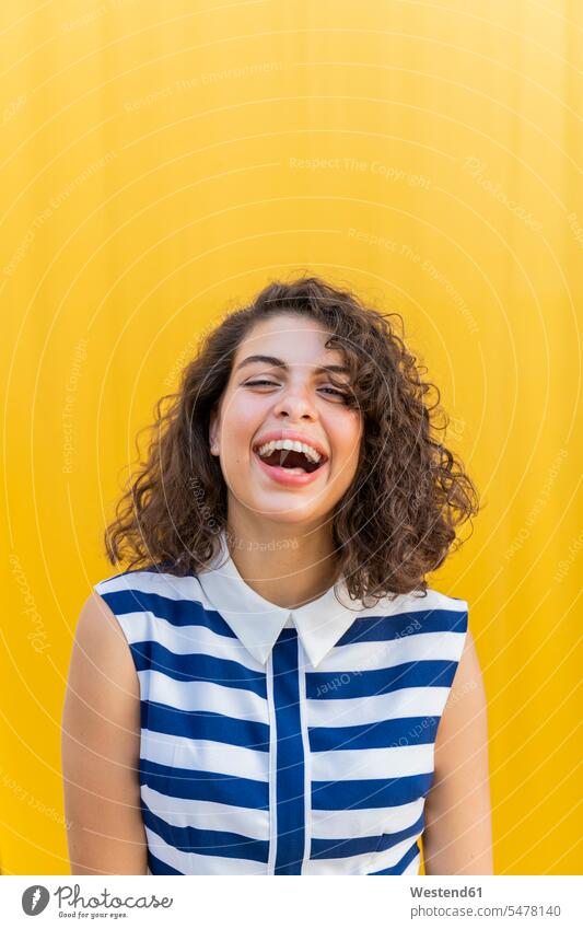 Portrait of happy young woman, yellow background human human being human beings humans person persons caucasian appearance caucasian ethnicity european 1