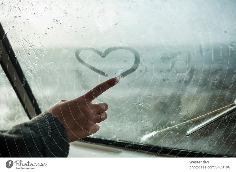 Woman's finger drawing a heart on the window of a van human human being human beings humans person persons celibate celibates singles solitary people