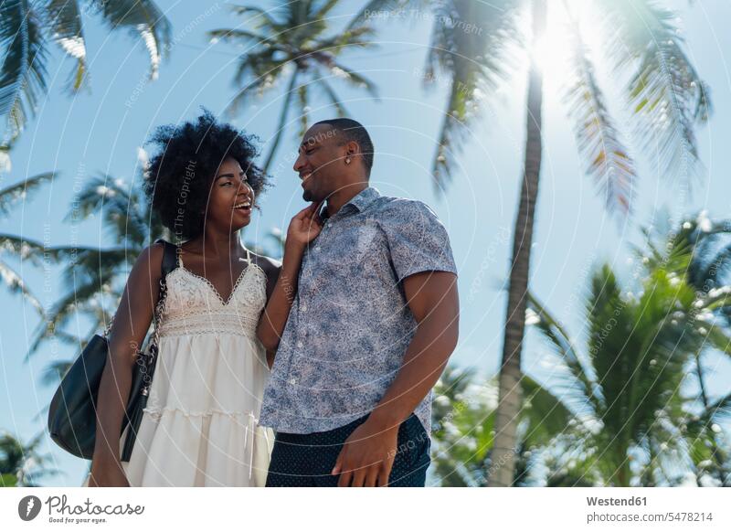 USA, Florida, Miami Beach, happy young couple at palm trees in summer twosomes partnership couples summer time summery summertime Palm Palm Trees Palms
