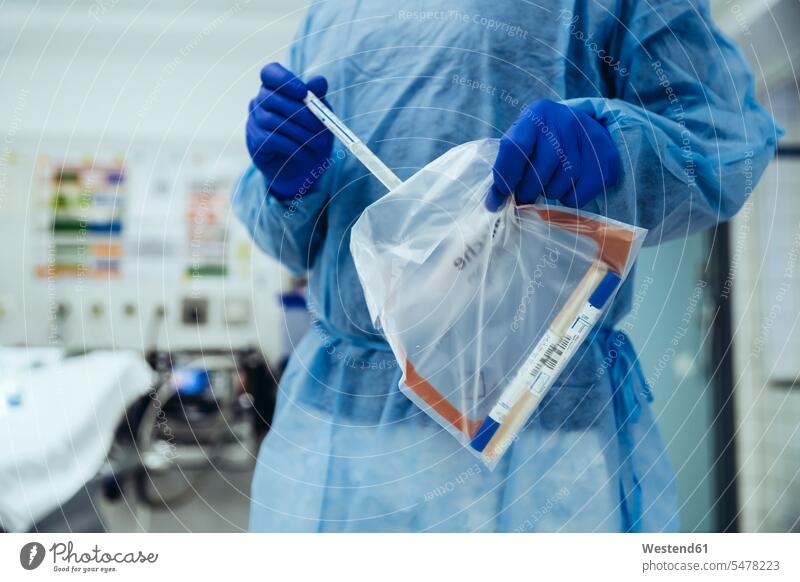 Close-up of emergeny doctor putting a swab into a plastic bag in hospital (value=0) Occupation Work job jobs profession professional occupation At Work hold