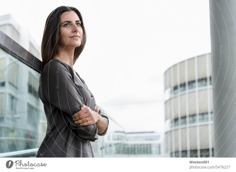 Portrait of young businesswoman looking at distance businesswomen business woman business women view seeing viewing portrait portraits business people