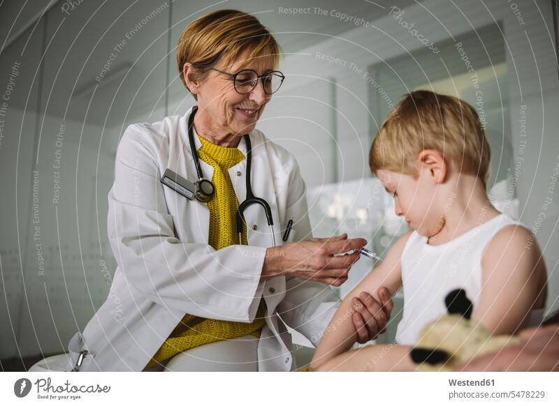 Pediatrist injecting vaccine into arm of toddler health healthcare Healthcare And Medicines medical medicine disease diseases ill illnesses sick Sickness
