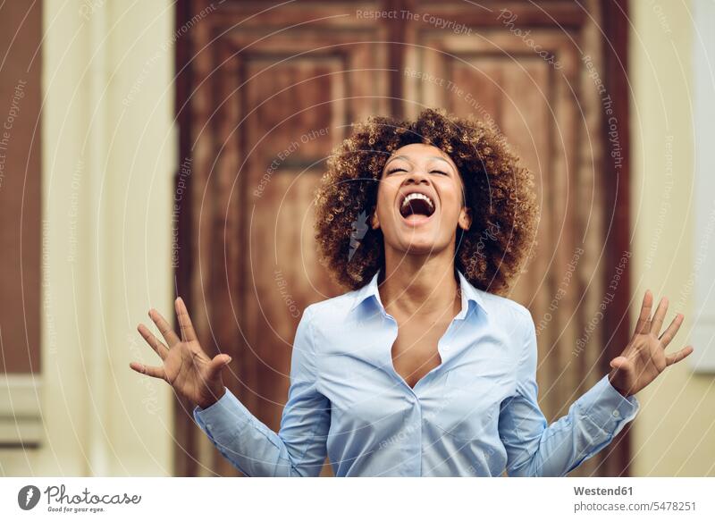 Portrait of woman with afro hairstyle screaming outdoors Afro Afros females women portrait portraits shouting people persons human being humans human beings