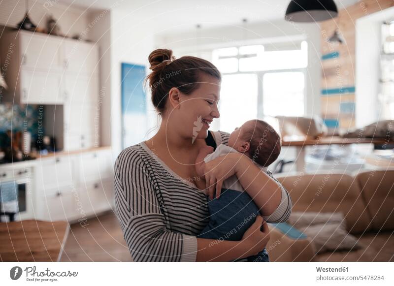 Portrait of a young woman with a baby at home human human being human beings humans person persons caucasian appearance caucasian ethnicity european 2 2 people
