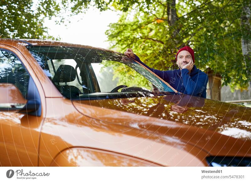 Mature man leaning on car in nature natural world automobile Auto cars motorcars Automobiles rested on men males motor vehicle road vehicle road vehicles