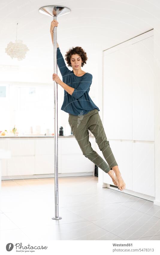 Woman doing pole dance at home woman females women pole dancing Adults grown-ups grownups adult people persons human being humans human beings casual