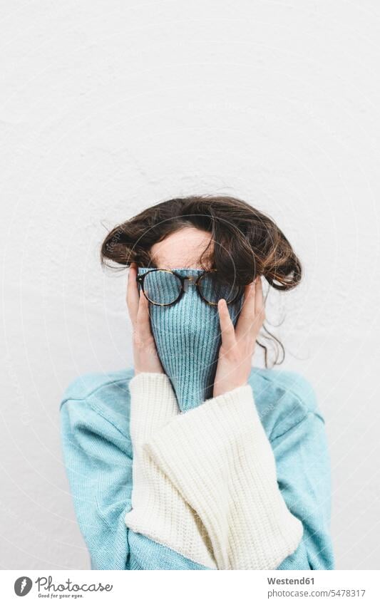 Young woman covering her face with turtle neck Eye Glasses Eyeglasses specs spectacles hide colour colours White Colors Humor Humorous Lifestyle fashionable