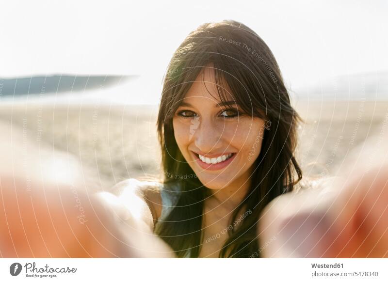 Portrait of a smiling young woman on the beach heads faces human face human faces relax relaxing smile summer time summertime summery relaxation delight