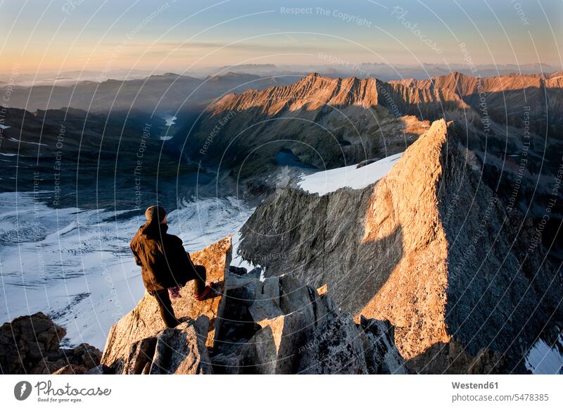 Austria, Tyrol, Zillertal Alps, View from Reichenspitze, climber at glaciated mountains at sunrise, Wildgerlostal, High Tauern National Park man men males