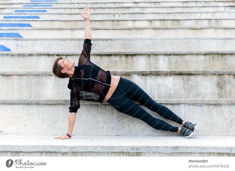 Athletic woman during workout on stairs, side plank human human being human beings humans person persons caucasian appearance caucasian ethnicity european 1