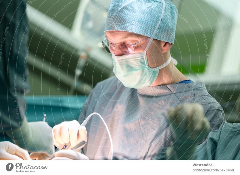 Surgeon during surgery human human being human beings humans person persons caucasian appearance caucasian ethnicity european Eastern European Group