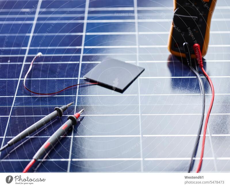 Silicon solar cell with wires on solar panel with measuring device contemporary engineering technologies green technology measurement measurements measurings
