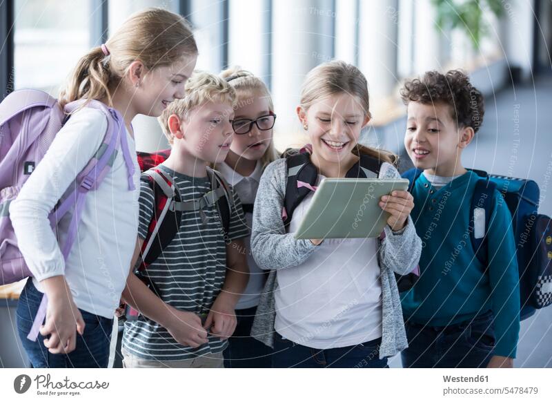 Happy pupils looking at tablet on school corridor eyeing happiness happy schools digitizer Tablet Computer Tablet PC Tablet Computers iPad Digital Tablet