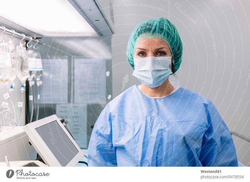 Female pharmacist wearing medical scrubs standing in laboratory color image colour image Spain indoors indoor shot indoor shots interior interior view Interiors