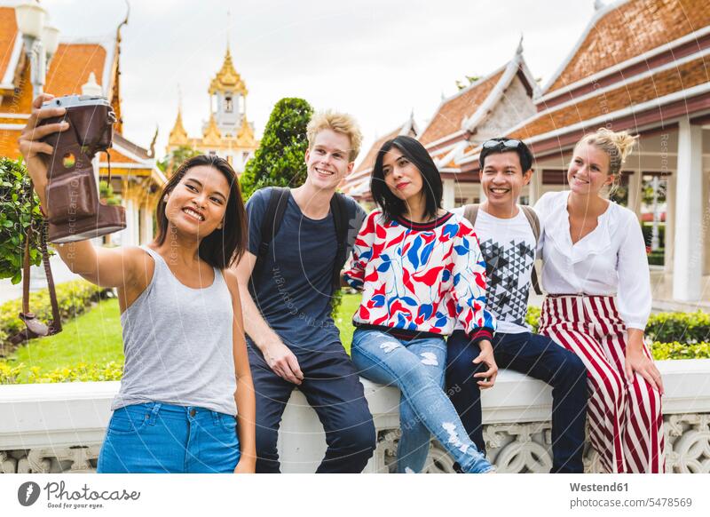 Thailand, Bangkok, five friends taking selfie with smartphone in front of temple complex camera cameras taking a photo Taking Photos Taking A Picture