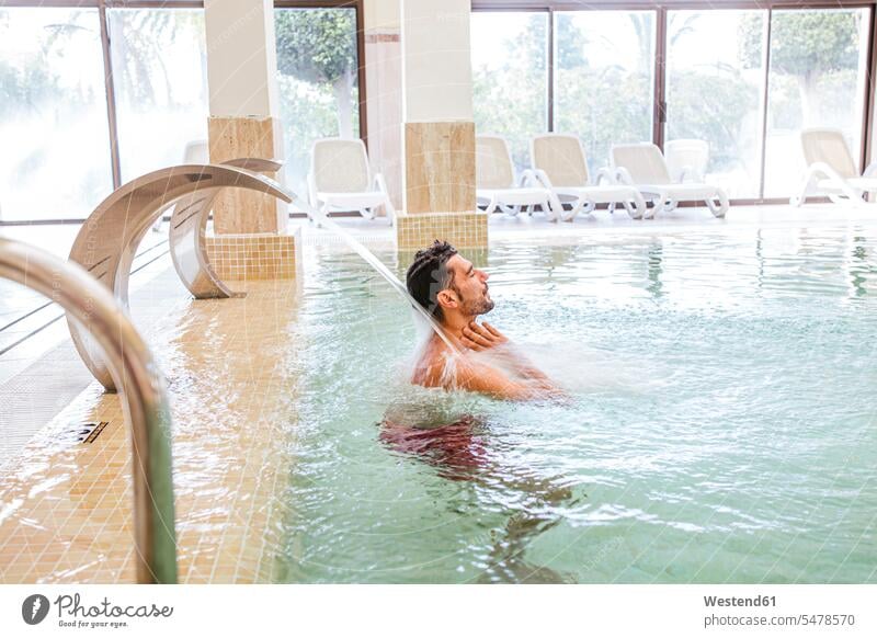 Man relaxing in swimming pool of a spa (value=0) windows relaxation enjoy enjoyment indulgence indulging savoring free time leisure time Lifestyle wellbeing