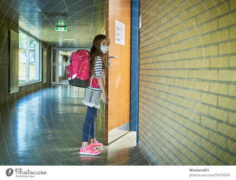 Girl wearing mask in school opening classroom door pupils schoolchild schoolchildren colour colours Rosy healthy protect protecting safe Safety secure buildings