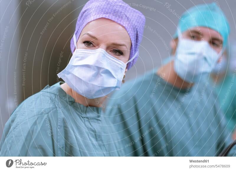 Neurosurgeons in scrubs during an operation surgical gown Operating Gown portrait portraits hospital Medical Clinic surgery surgeries operating doctor