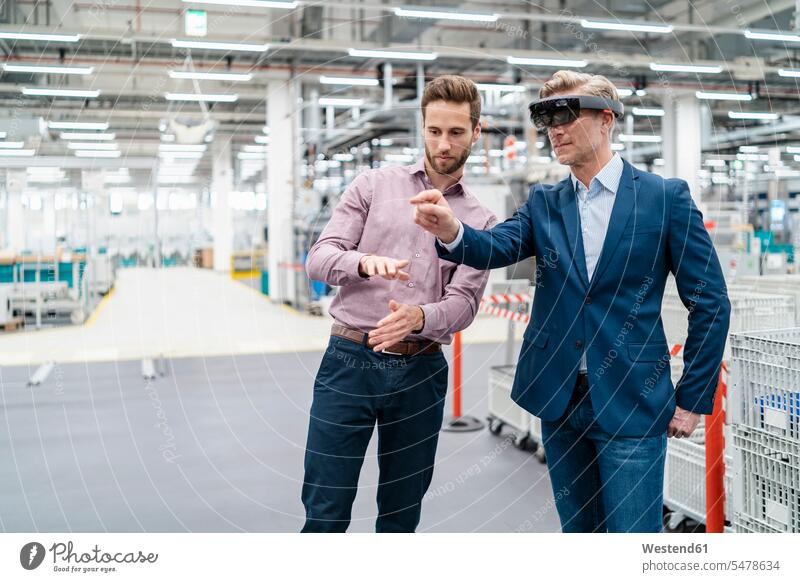 Two businessmen with AR glasses in a modern factory colleague associate associates partner partners partnerships Occupation Work job jobs profession