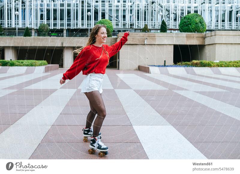 Happy young woman roller skating in the city human human being human beings humans person persons caucasian appearance caucasian ethnicity european 1