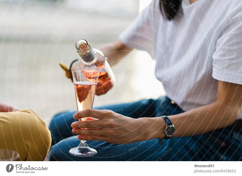 Close-up of woman pouring in sparkling blush wine Sparkling Wine champagne couple twosomes partnership couples Alcohol alcoholic beverage Alcoholic Drink