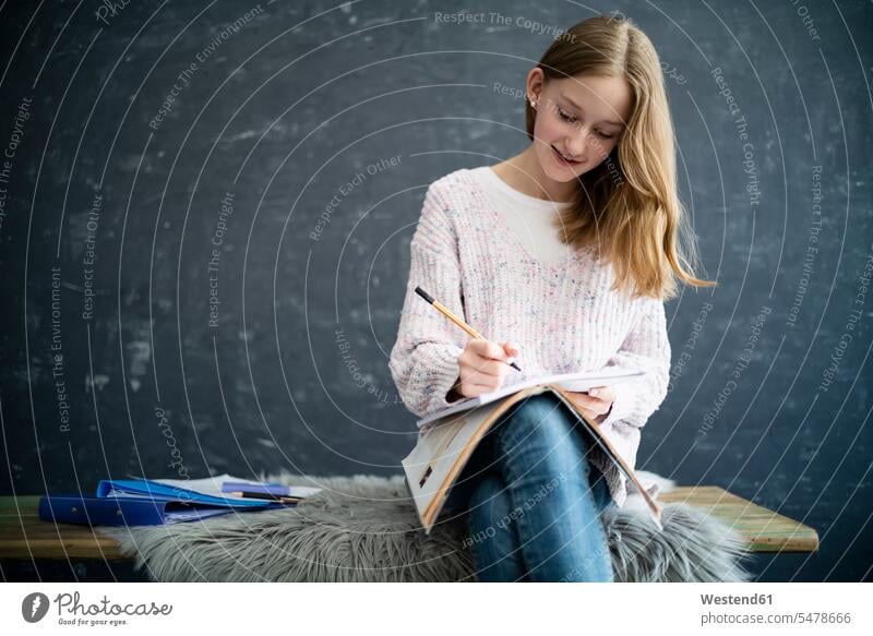 Girl learning at home, writing in exercise book read human human being human beings humans person persons 1 one person only only one person children kid kids