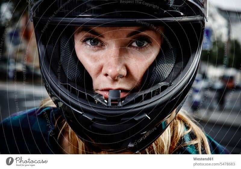 Portrait of confident young woman wearing motorcycle helmet confidence females women portrait portraits motorbike Motor Cycle Adults grown-ups grownups adult