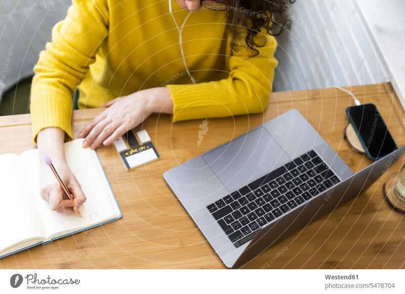 Close-up of woman working at desk in home office taking notes human human being human beings humans person persons caucasian appearance caucasian ethnicity