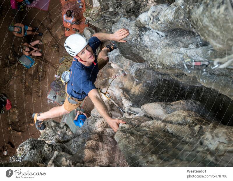 Thailand, Krabi, Railay Beach, man climbing in rock wall rock face escarpment males rocks Adults grown-ups grownups adult people persons human being humans