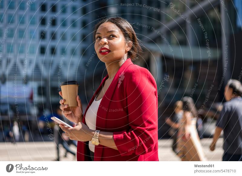 Portrait of businesswoman with coffee to go and cell phone, London, UK business life business world business person businesspeople business woman business women