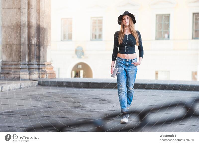 Fashionable young woman walking at historic building in city color image colour image outdoors location shots outdoor shot outdoor shots day daylight shot