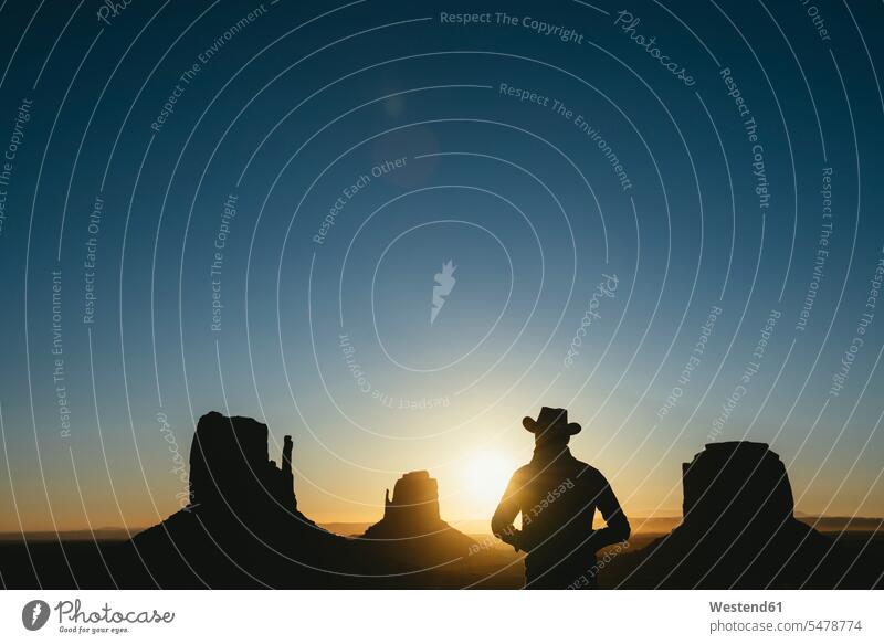 USA, Utah, Monument Valley, silhouette of man with cowboy hat watching sunrise cowboy hats looking looking at silhouettes sun rise sunrises males view seeing