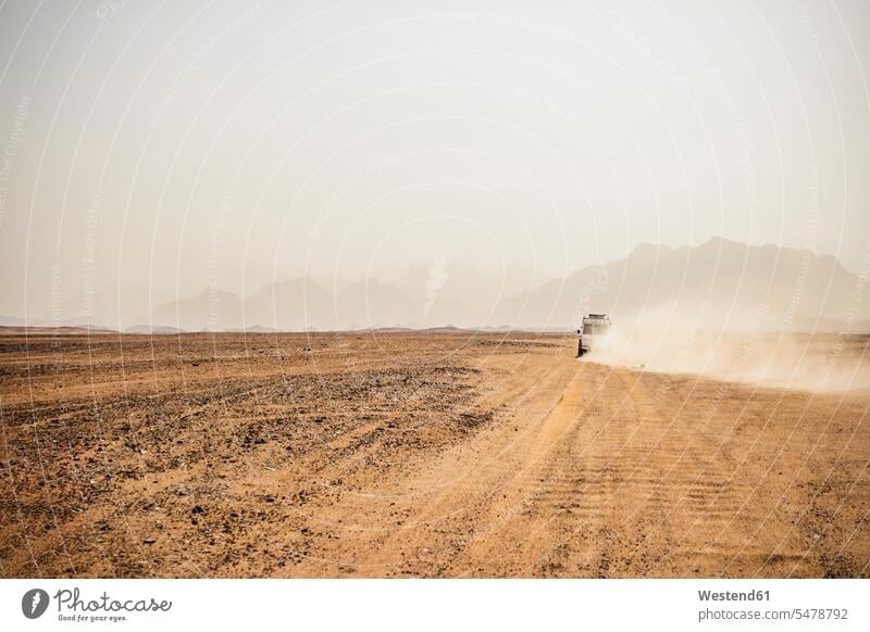 Off-road vehicle moving on arid landscape against clear sky, Suez, Egypt drought dryness drouth Arid Climate climate clime environment environmental