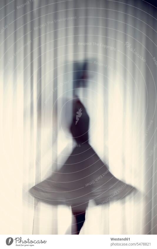 Silhouette of a young woman dancing in front of a white curtain dress dresses Contour wipe effect unreal apparitional only one woman one woman only 1 1 woman