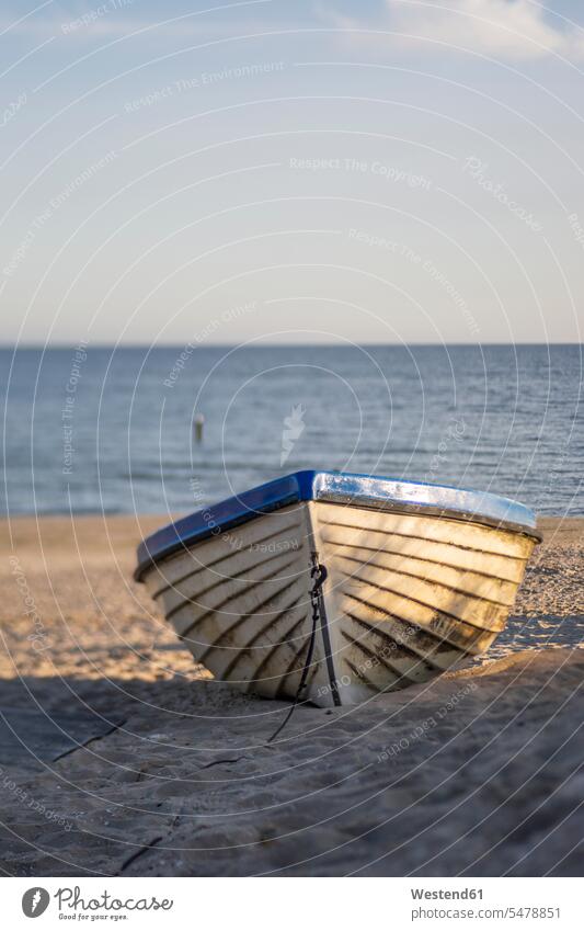 Boat left on sandy beach at dawn outdoors location shots outdoor shot outdoor shots morning twilight in the morning atmosphere boat boats vessel water vehicle