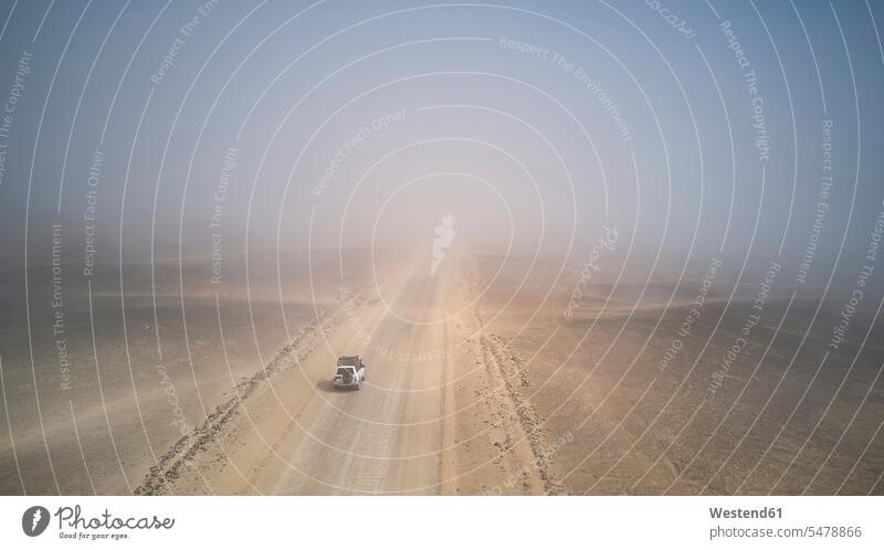 Drone view of a 4x4 in the foggy desert, Namibia (value=0) drive Landscape - Nature Landscape - Scenery landscapes scenery terrain extreme terrains text space