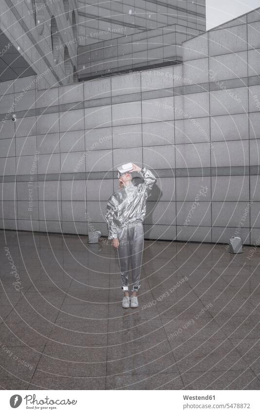 Girl in silver suit lookinng through VR goggles human human being human beings humans person persons caucasian appearance caucasian ethnicity european 1