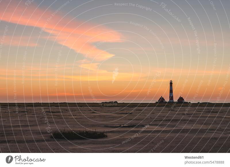 Germany, Schleswig-Holstein, Westerhever, Sandy beach at dawn with Westerheversand Lighthouse in background outdoors location shots outdoor shot outdoor shots