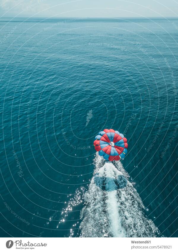 Indonesia, Bali, Nusa Dua, Aerial view of person parasailing and motorboat outdoors location shots outdoor shot outdoor shots day daylight shot daylight shots
