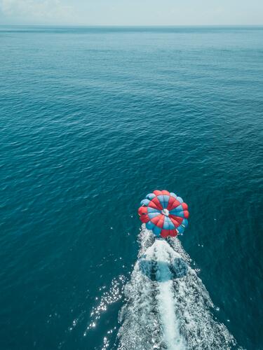 Indonesia, Bali, Nusa Dua, Aerial view of person parasailing and motorboat outdoors location shots outdoor shot outdoor shots day daylight shot daylight shots