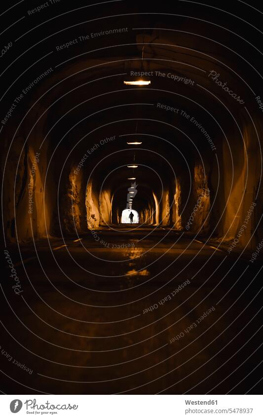 Norway, Lofoten Islands, Maervoll, silhouette of man in tunnel 30-35 years 30 to 35 30 to 35 years Adventure adventurous Adventures illuminated lit lighted